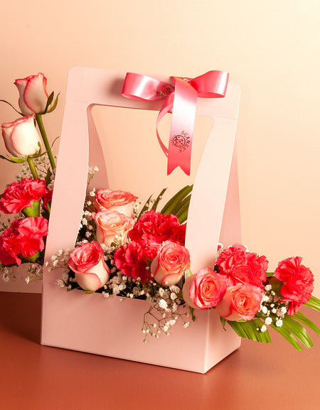 flower bouquet near me - pink roses arranged in a Pink paper bag