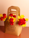 flower delivery to pune - carnations and chrysanthemums arranged in a paper bag
