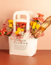 bouquet delivery online - Yellow Roses and Peach Carnations with fillers arranged in a Paper Bag