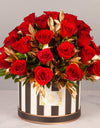 flower bouquet near me - red roses and gold leaves arranged in a striped box