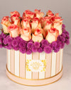 flower bouquet online delivery - pink roses and purple filler arranged in a striped box